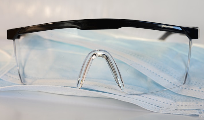 black framed eyeglasses on white textile