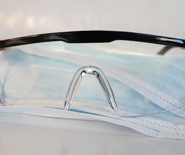 black framed eyeglasses on white textile