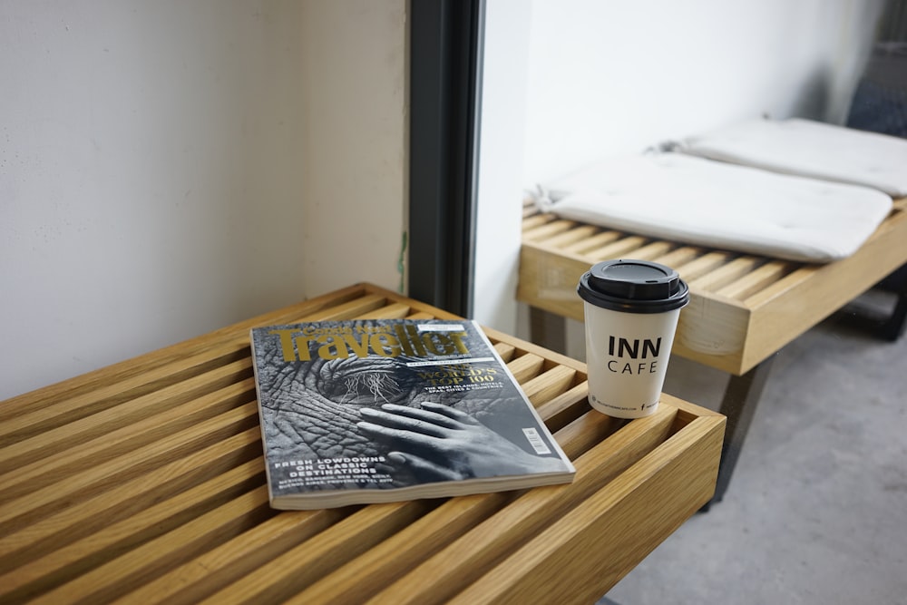 white and black plastic cup on brown wooden table