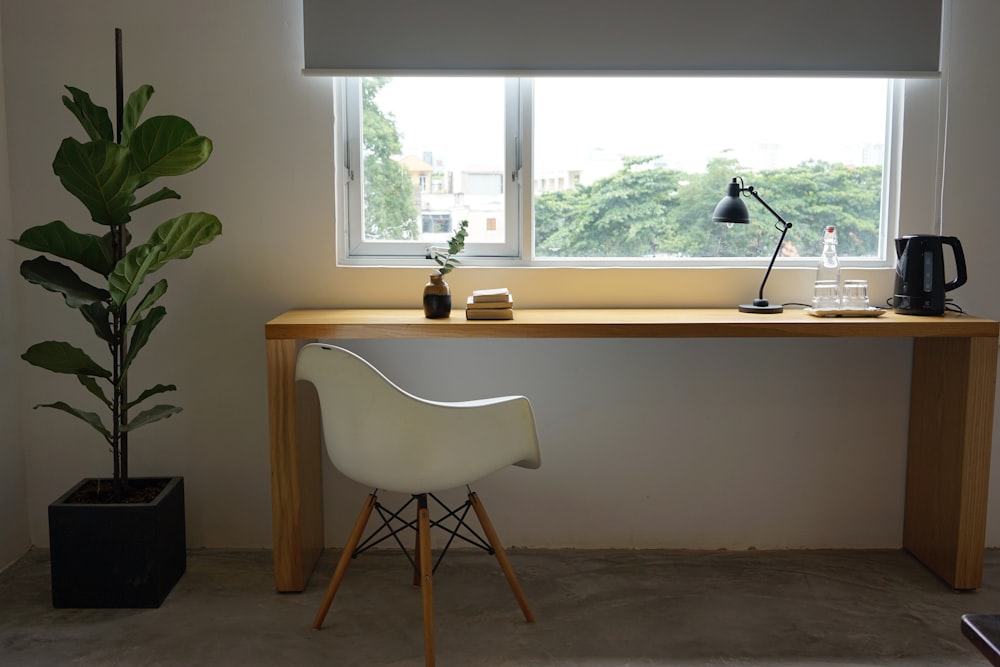 white wooden table near window