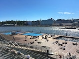 View of the sparkling wave pool with families enjoying the water under sunny skies.