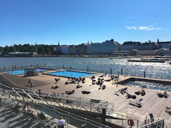 View of the sparkling wave pool with families enjoying the water under sunny skies.