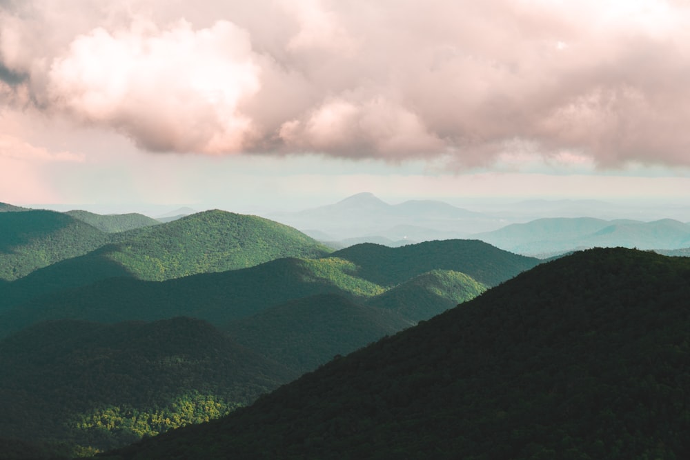 green mountains under white clouds during daytime