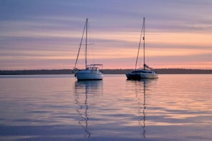white and blue boat on sea during daytime