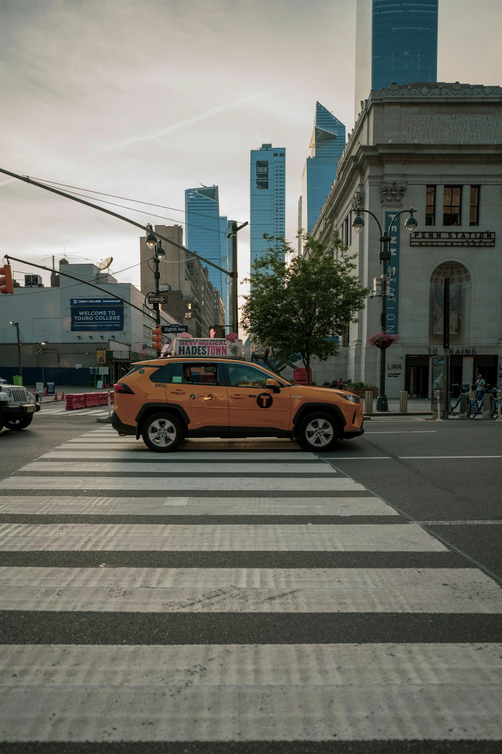 yellow cab on pedestrian lane during daytime