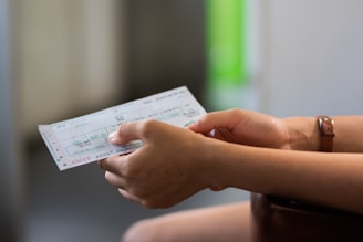 person holding white printer paper
