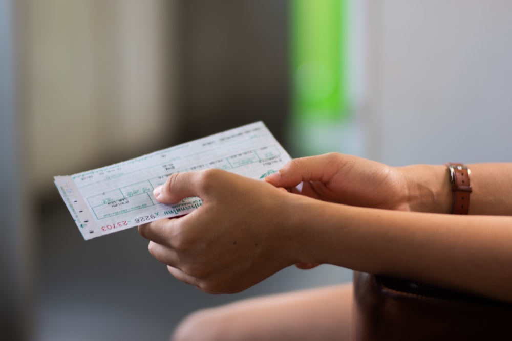 person holding white printer paper