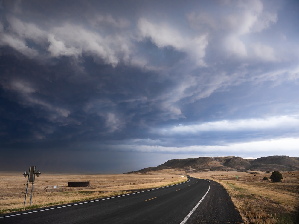 gray asphalt road under blue sky