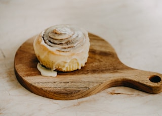 white and brown pastry on brown wooden spoon