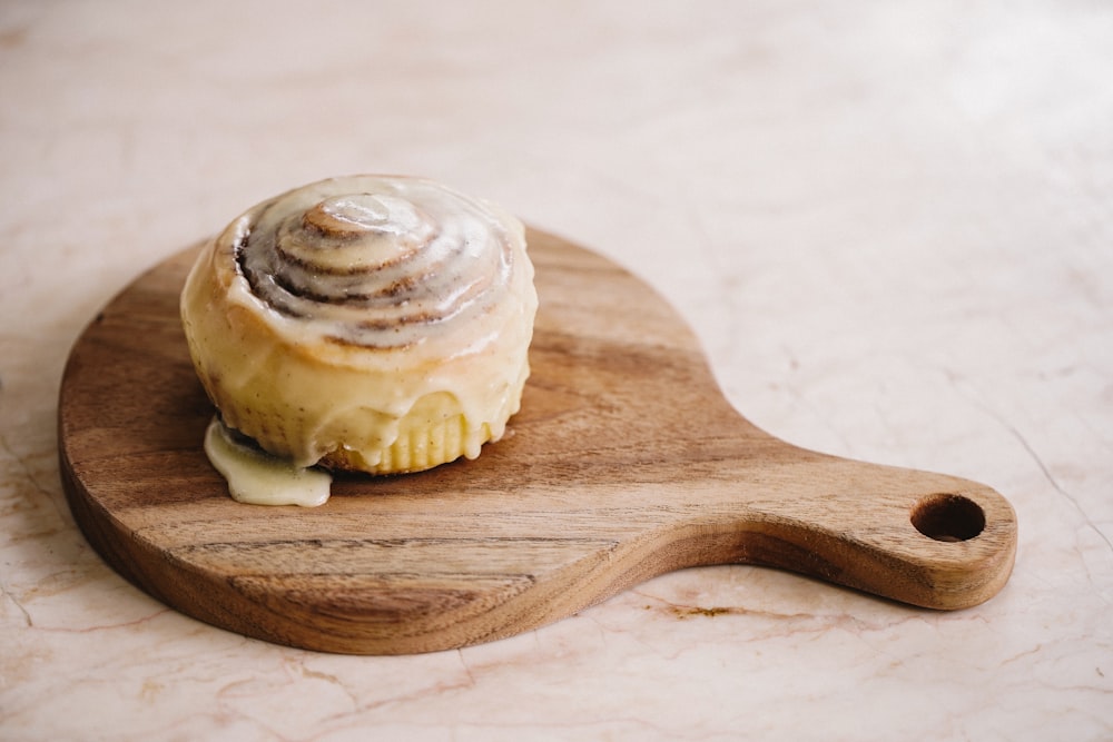 brown wooden spoon with white and brown pastry