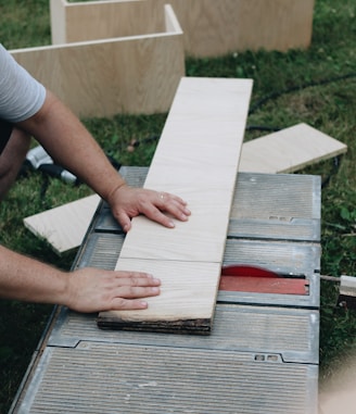 person holding white wooden board