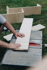 person holding white wooden board