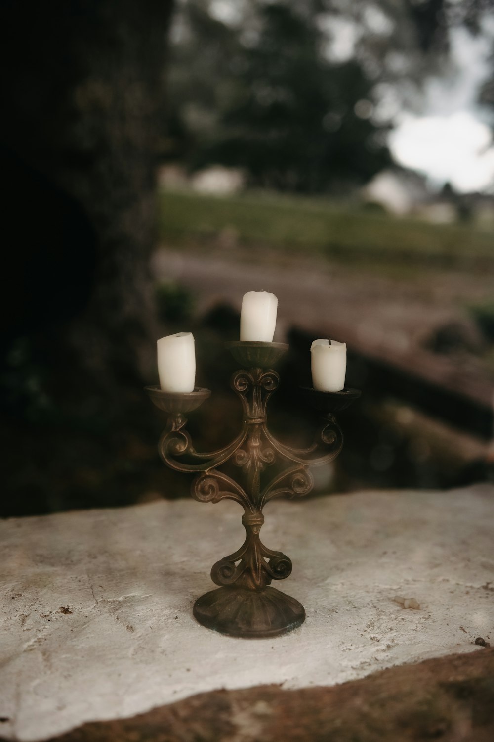 gold candle holder with white pillar candle