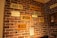 A red brick wall displays a variety of old signs and notices related to historical diseases. Prominent large signs include labels for chicken pox, small pox, diphtheria, measles, erysipelas, and whooping cough. Smaller signs display quarantine notices and information about influenza. There is also a sign related to mining camp medicine on the right side.