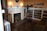A cozy vintage-style living room with a lit Edison Candle Company soy wax candle on a wooden side table.