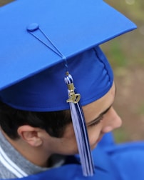person wearing blue academic hat