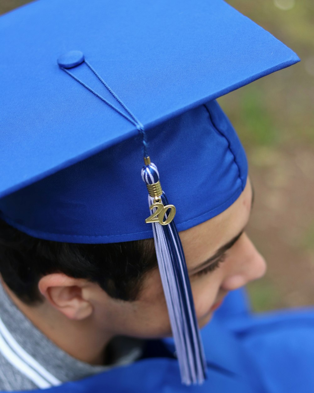 person wearing blue academic hat