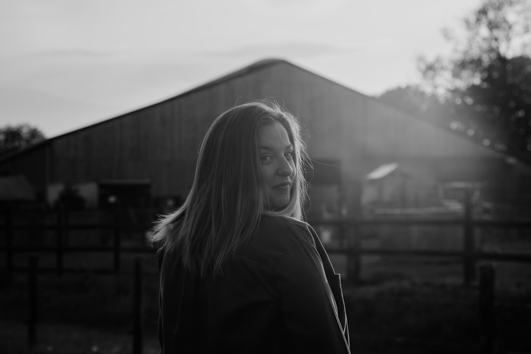 grayscale photo of woman in black coat