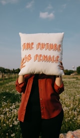 person holding white happy birthday throw pillow