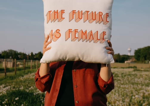 person holding white happy birthday throw pillow