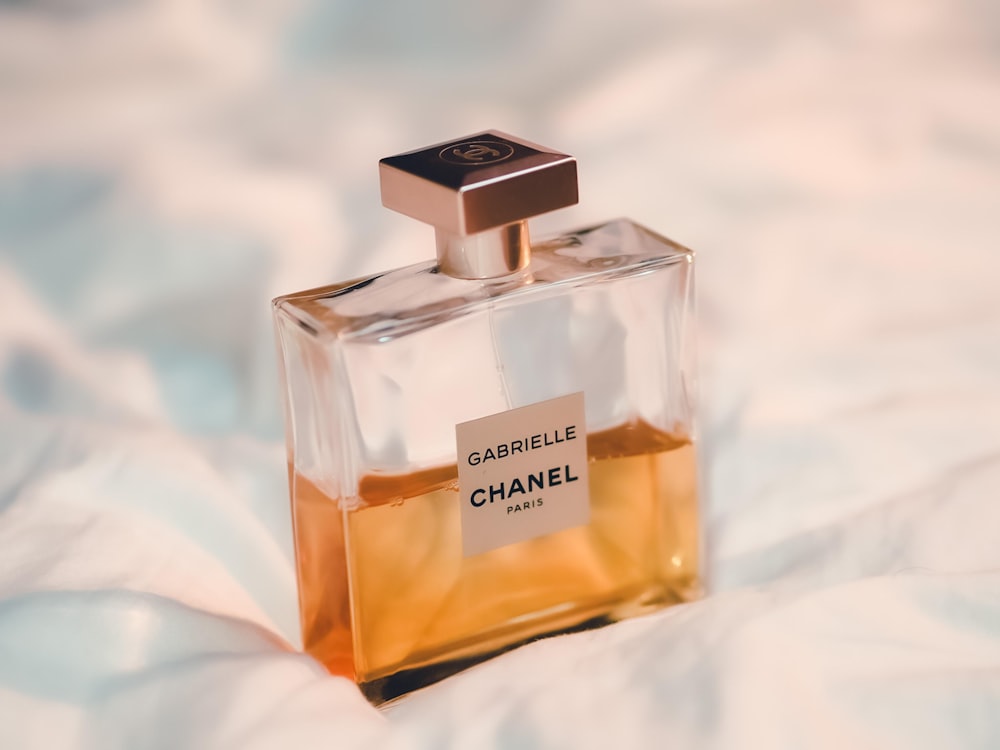 chanel perfume bottle on white textile