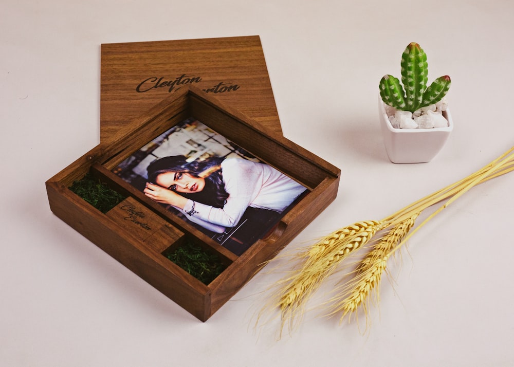 brown wooden picture frame on white table