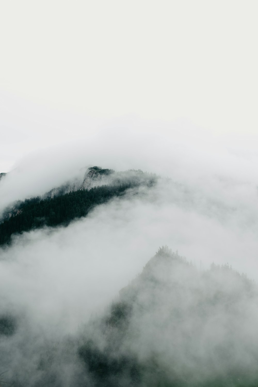 white clouds over mountain during daytime