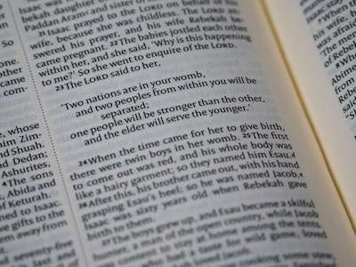 A close-up of a book page featuring text in a serif font. The text contains a quotation with a religious tone, discussing nations and sibling relationships. The paper appears slightly yellowed, suggesting age.