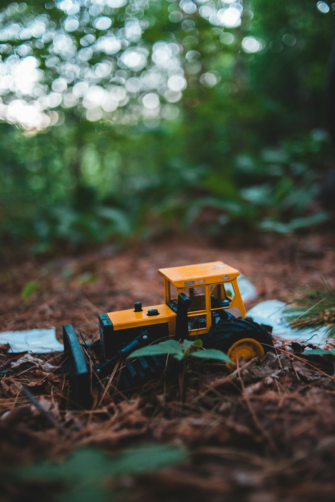 yellow and black tractor toy on ground