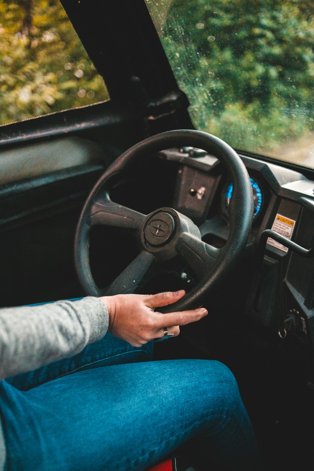 person in blue long sleeve shirt driving car