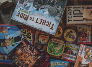 A vibrant assortment of board games stacked on a table.
