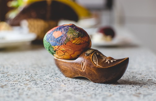 Close-up of a vibrant devotional painting by Carmen Taracena on an egg surface.