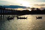 Sunset over the Amazon River with traditional boats floating gently on the water