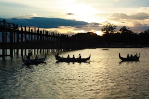 Sunset over the Amazon River with traditional boats floating gently on the water