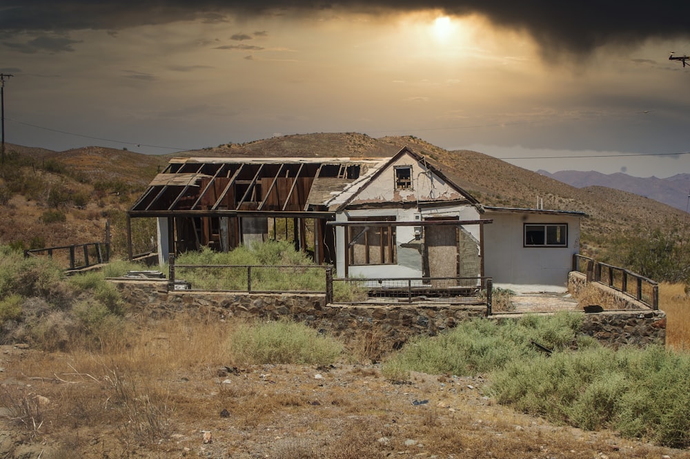 white and brown house near green grass field during daytime