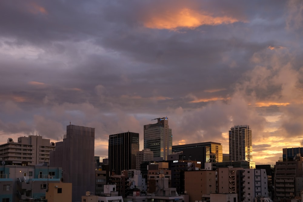 city buildings under cloudy sky during sunset