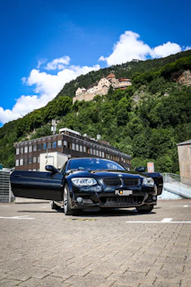 A sleek CityGlide taxi parked outside Cardiff Castle on a sunny day.