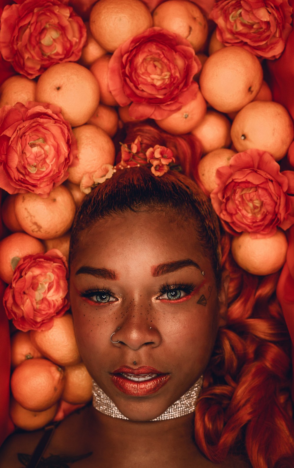 woman with pink rose petals on her face