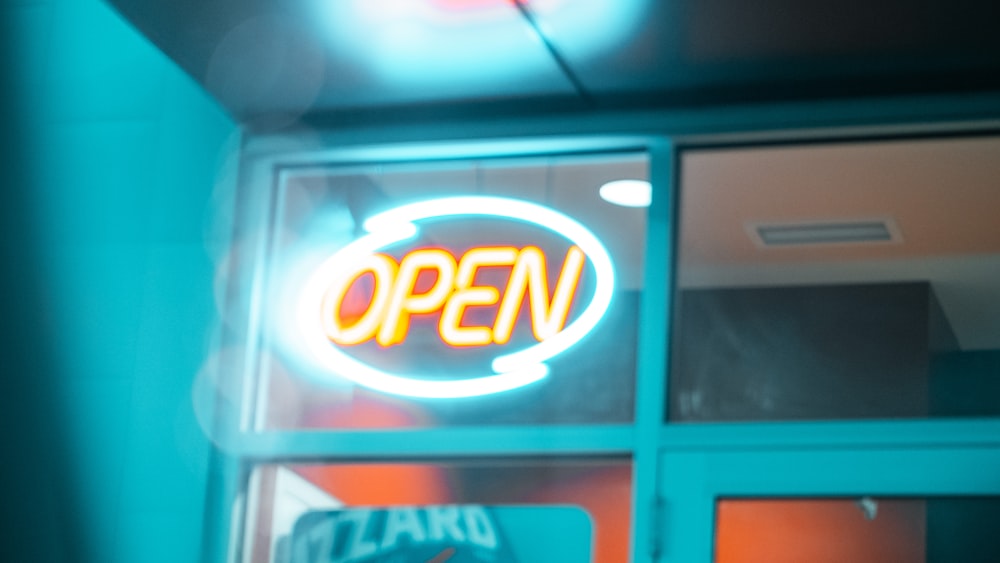 red and white open neon signage