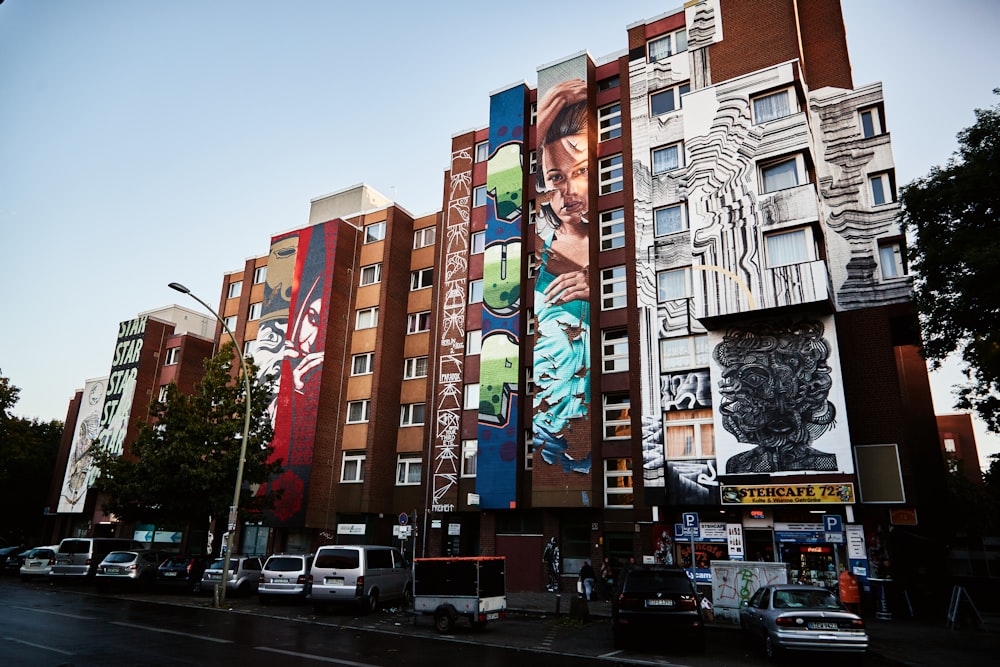 cars parked in front of red and white building during daytime