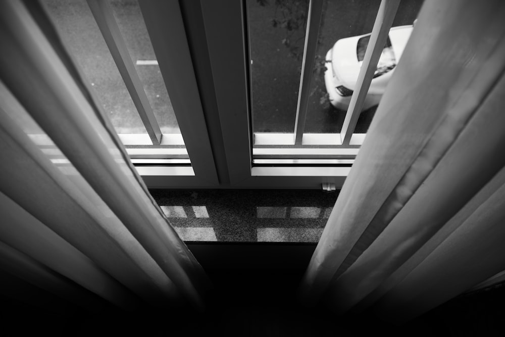 grayscale photo of window curtain