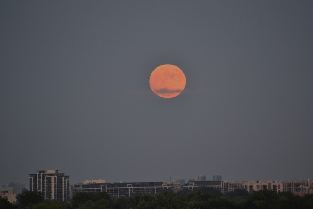 full moon over city buildings