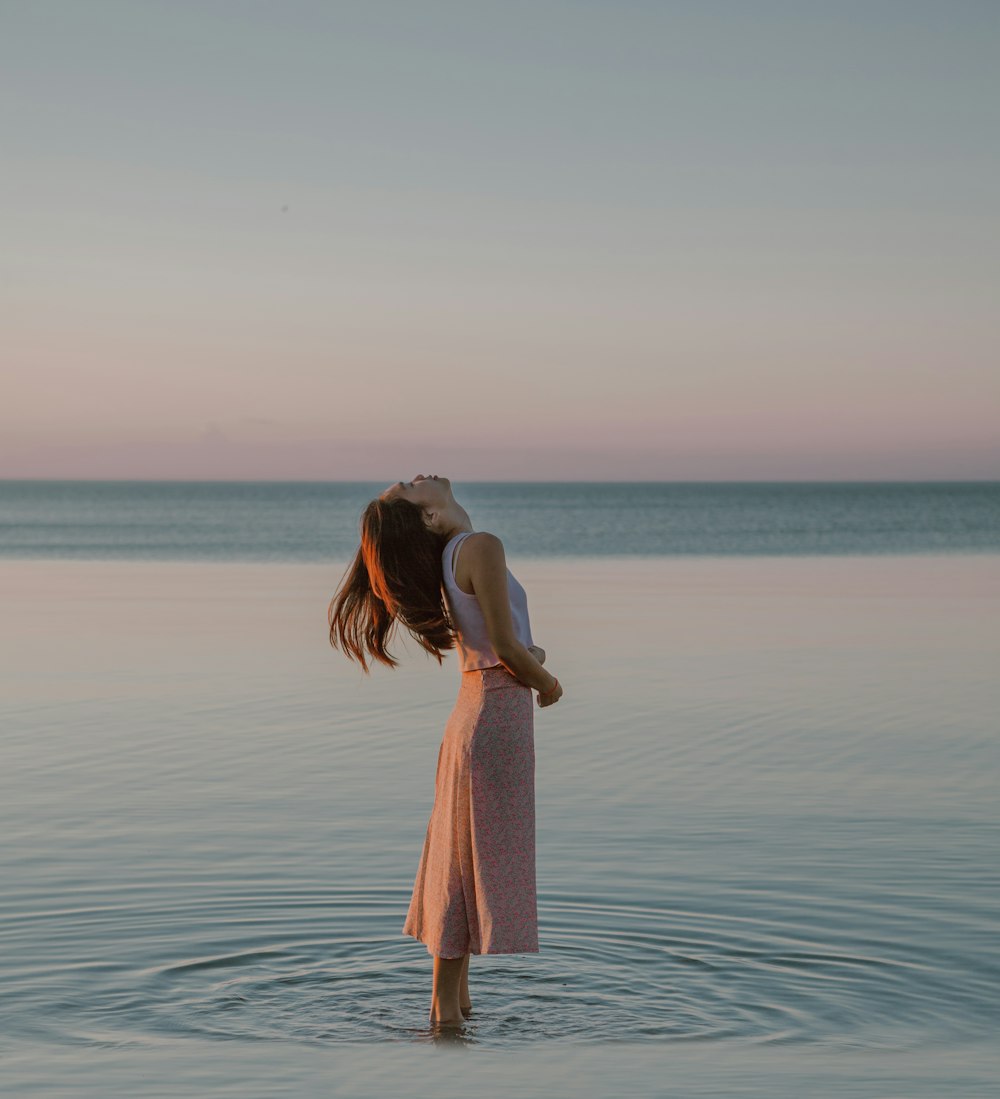 a woman standing in a body of water