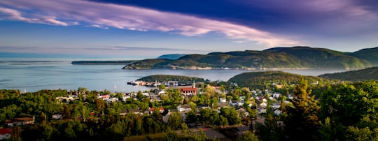 aerial view of city near body of water during daytime in Tadoussac Canada
