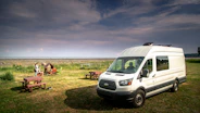 white van on green grass field during daytime