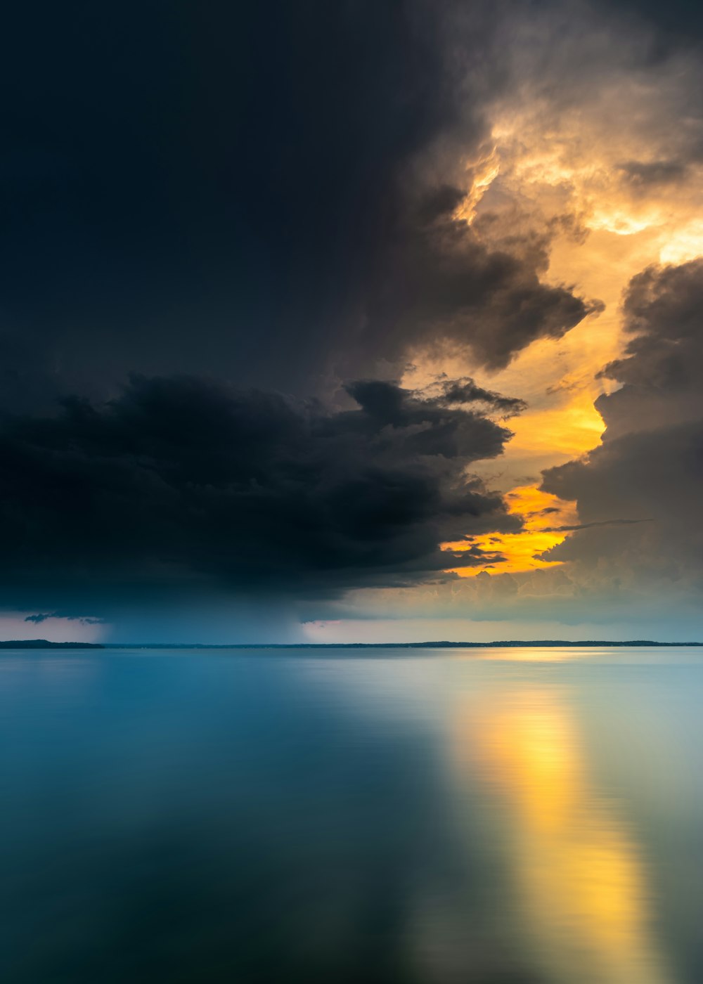 body of water under cloudy sky during daytime