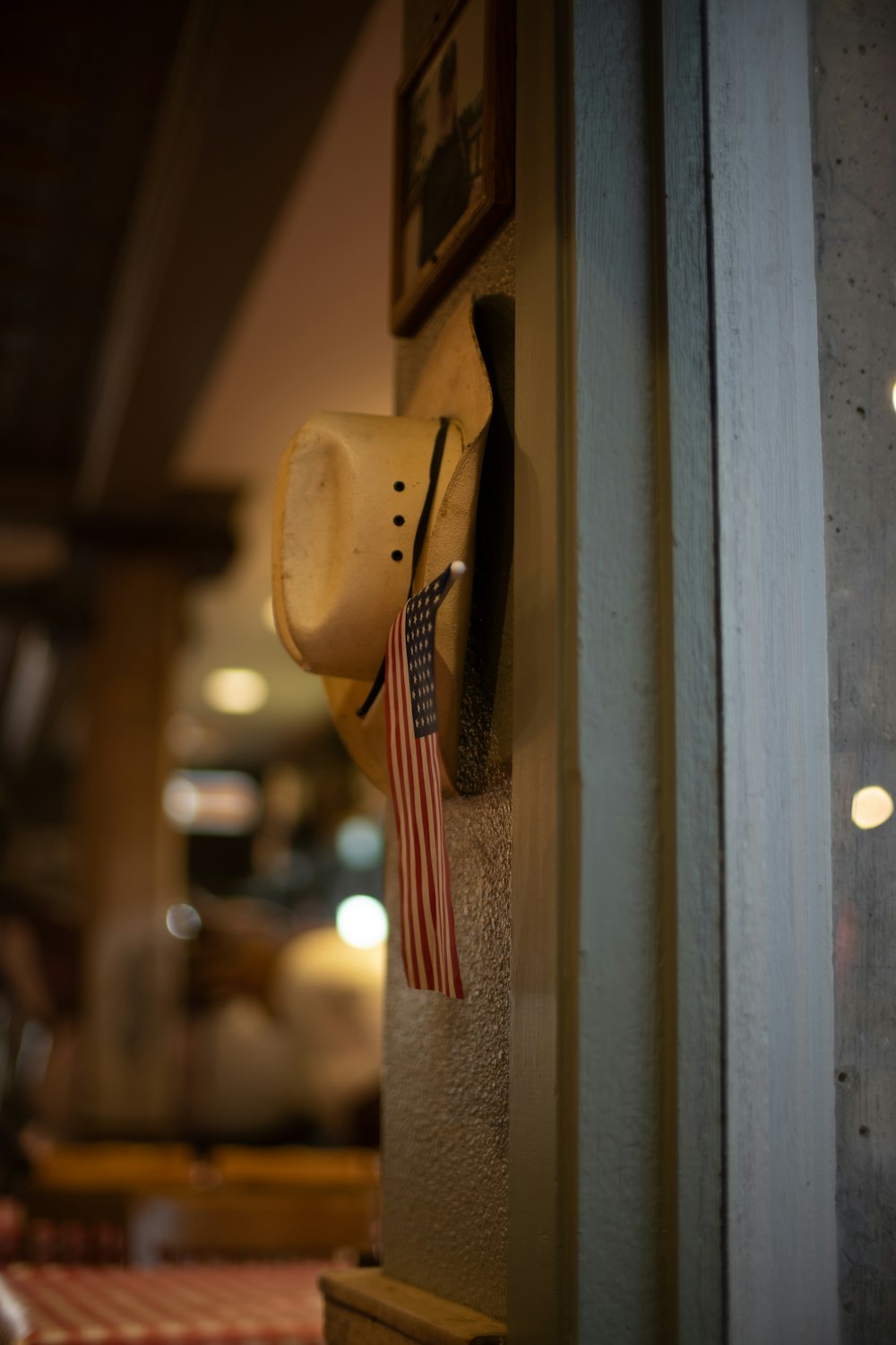 brown cowboy hat hanged on brown wooden wall