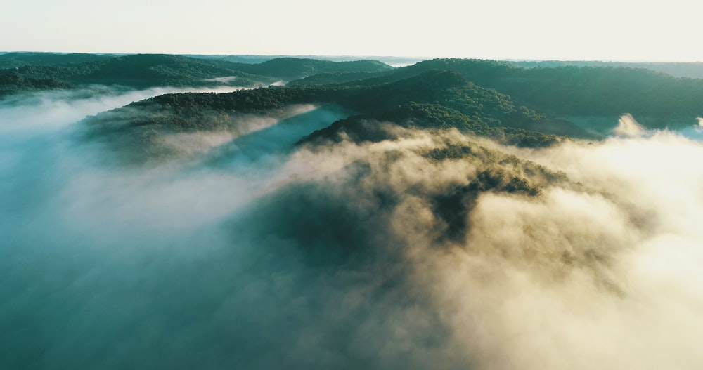 green mountain beside body of water during daytime