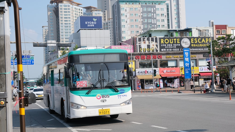 white and blue bus on road during daytime