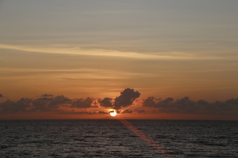 body of water during sunset